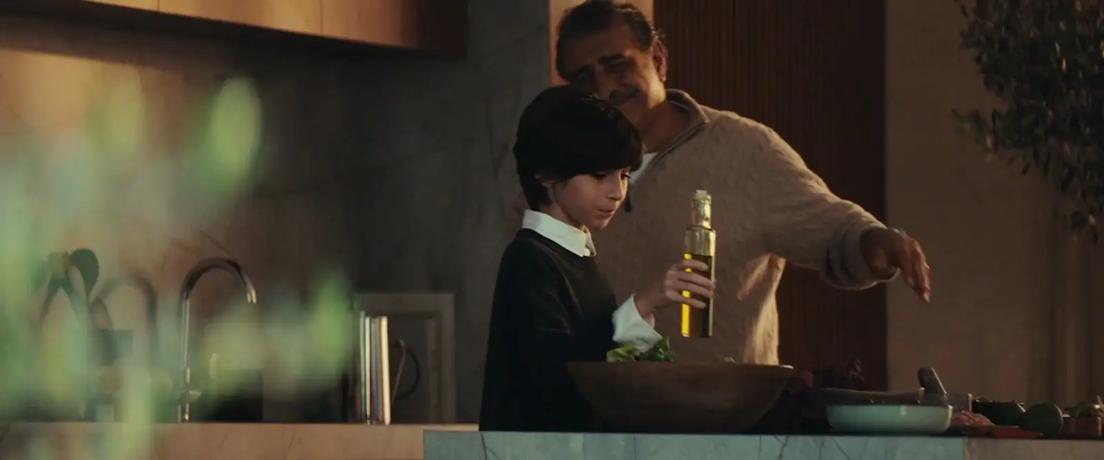 Still from Meraas's Phase 7 film: a family cooking together in a villa kitchen